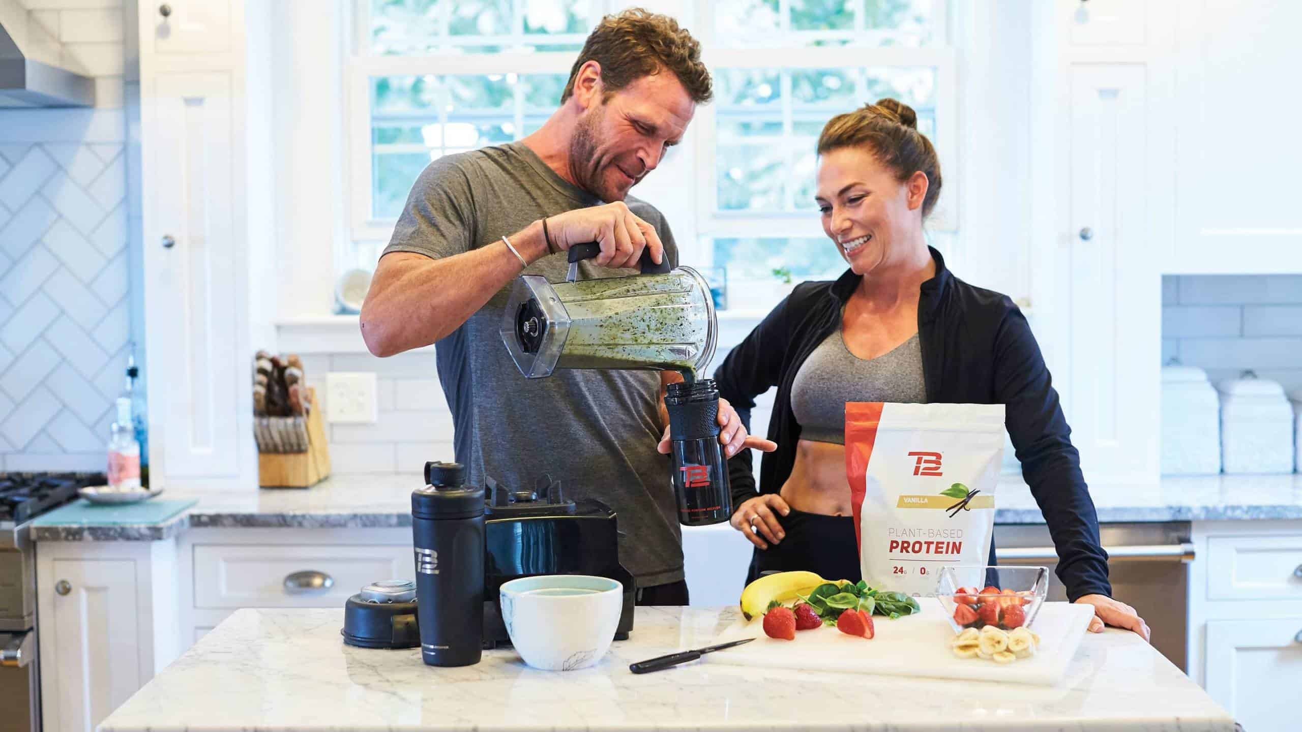 Man and woman pouring a smoothie into a cup